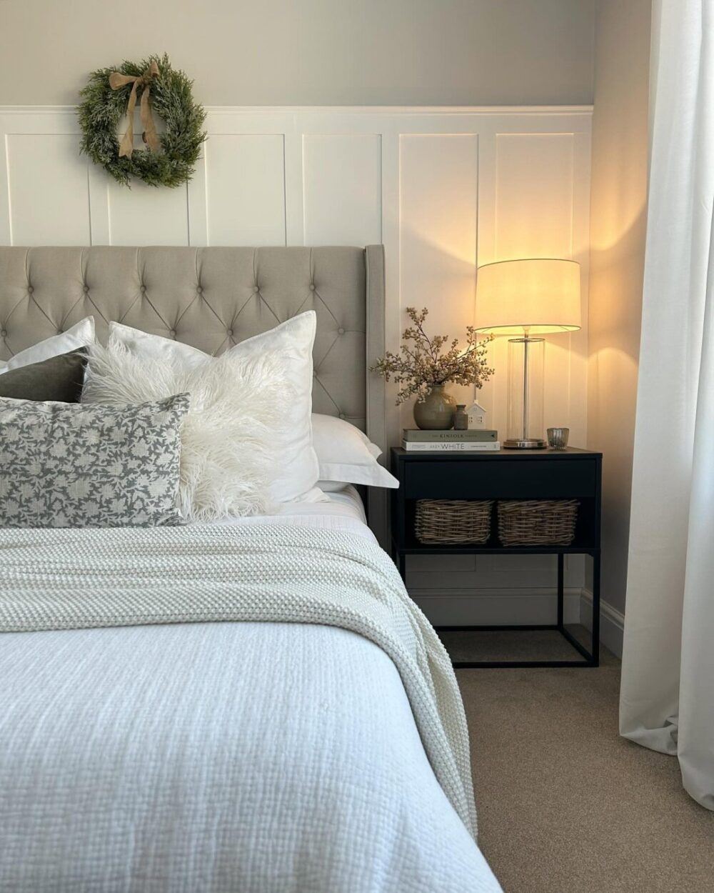 Beige bed frame, styled with festive wintry Christmas decorations and wreath