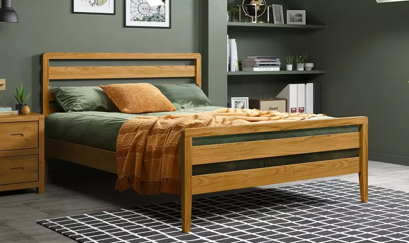 Green bedroom and wooden bed frame