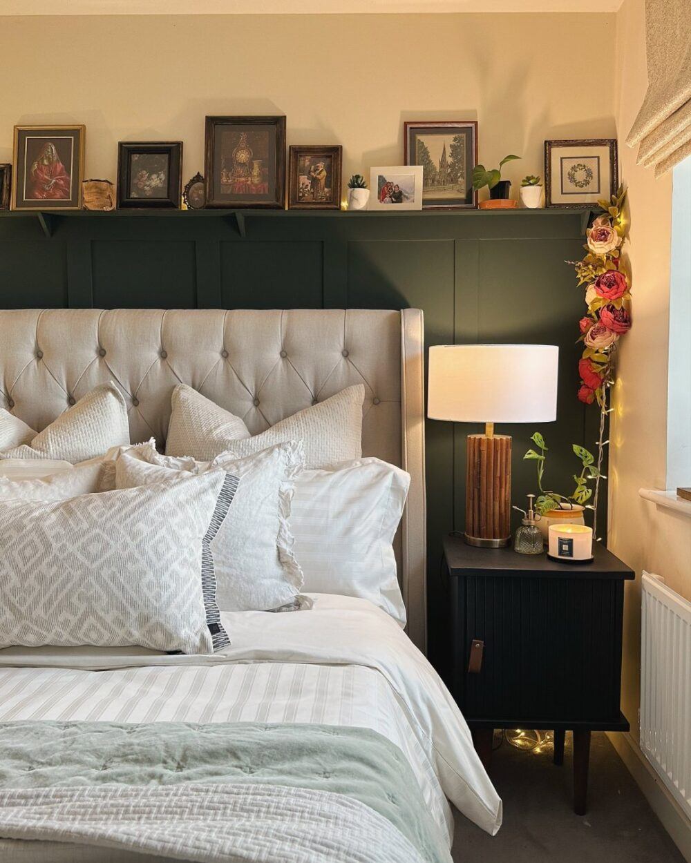 UGC by @handmadehome_durham featuring grey deacon bed and dark green panelled wall and picture frames.