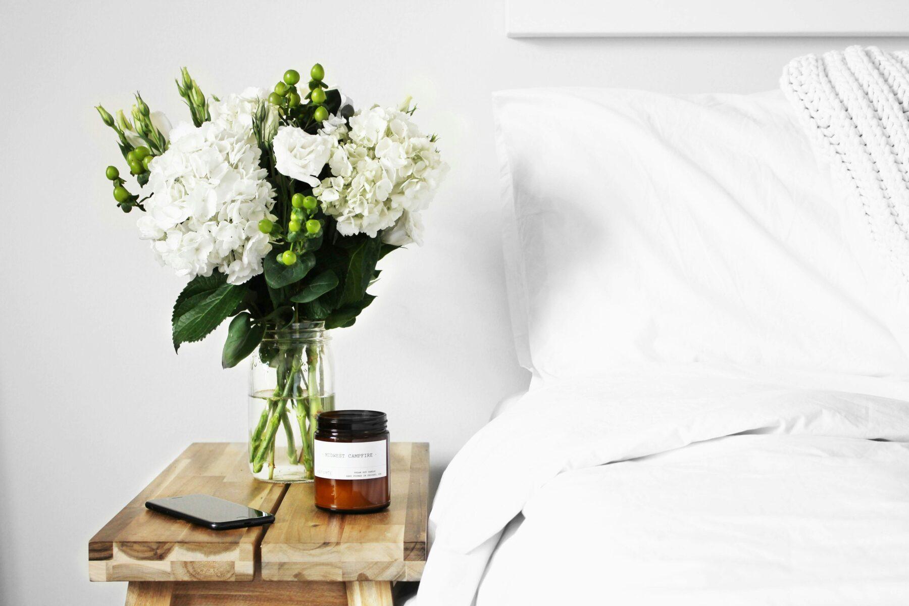 Bedroom bedside table with flower vase and candle