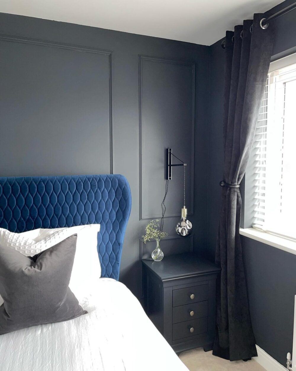 Blue headboard in a grey and white room