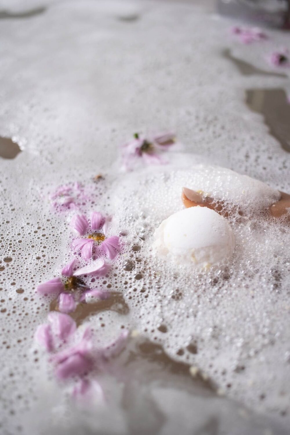 Bath water with bubbles and petals