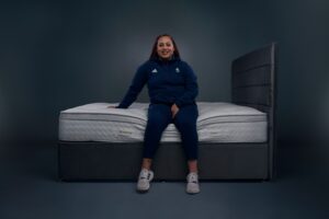 Emily Campbell, Team GB weightlifter, sat on a Dreams mattress