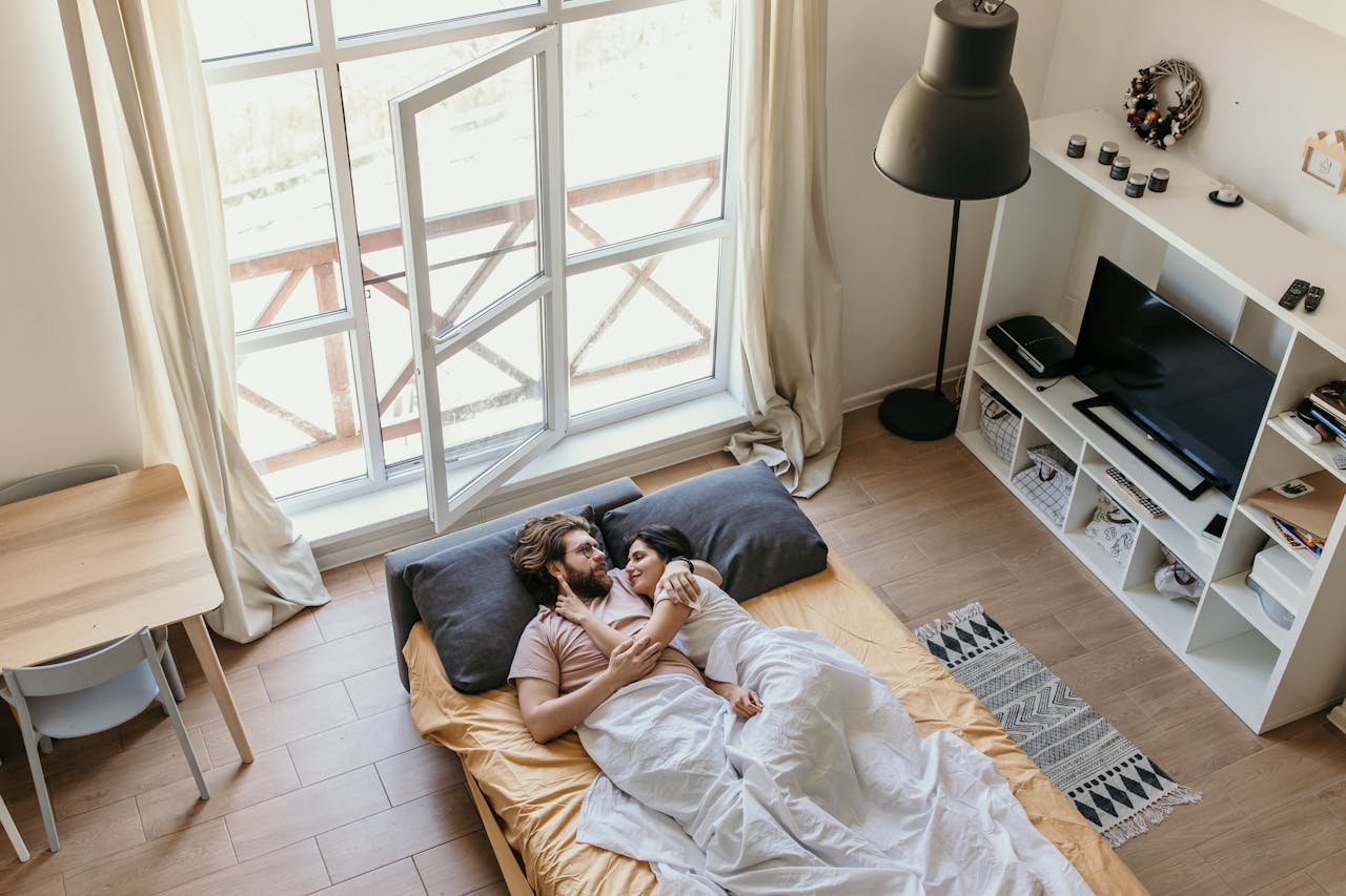 High angle of man and woman in in half spoon cuddle position