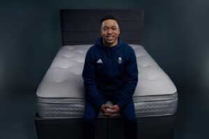 Image of Joe Fraser, Team GB gymnast, sat on a Dreams mattress