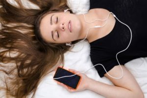 girl laying down with phone in hand