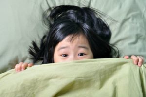 Little girl scared in bed after having nightmares