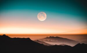 image of a moon in a light, dawn sky